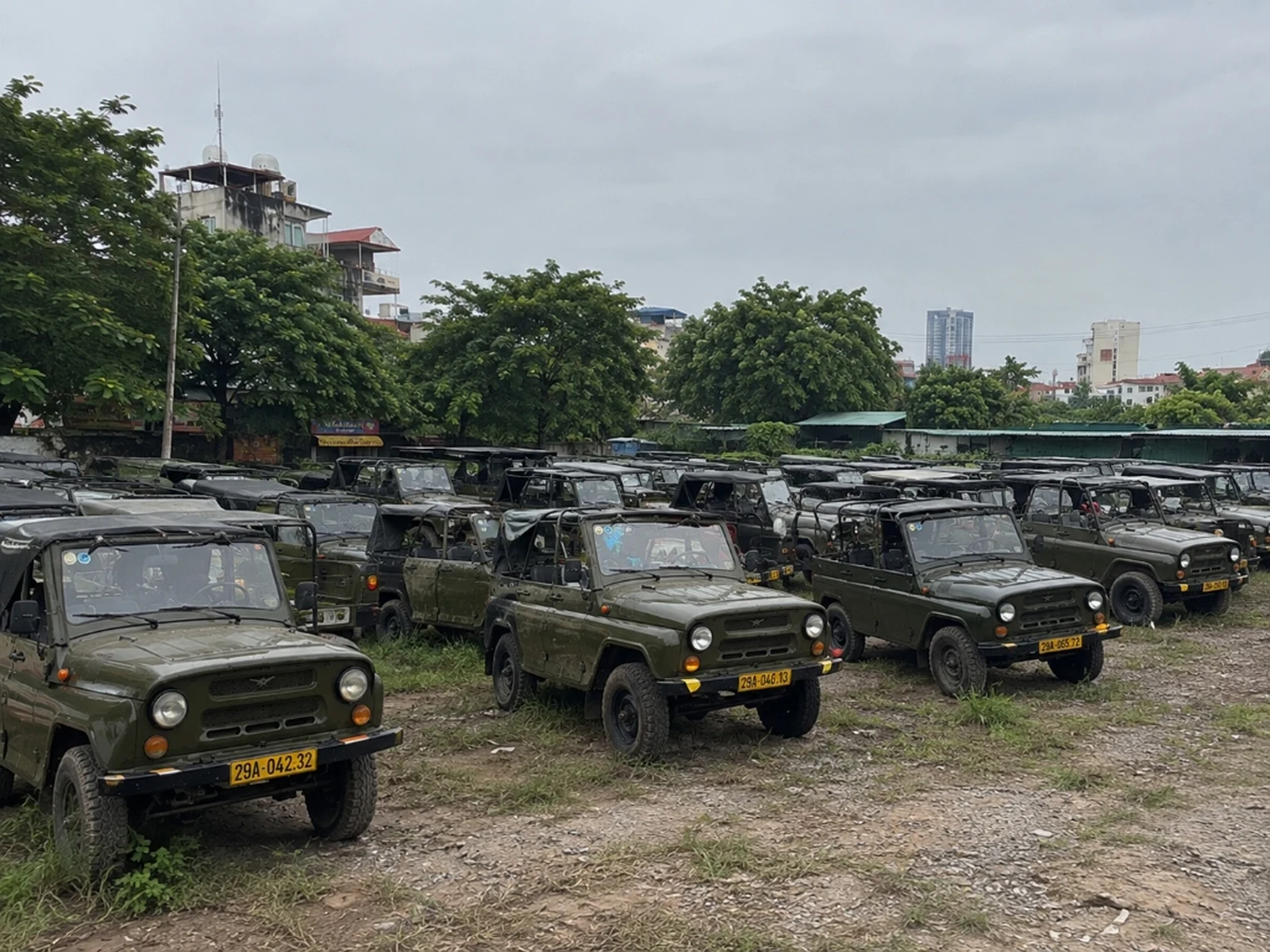 Rows of Soviet UAZ-469 army jeeps at Eco Trip Asia garage in Bo De, Long Bien, Hanoi